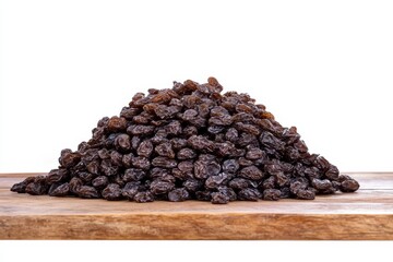 Fototapeta premium Scattered pile of dried raisins in deep brown color on white background, creating a texture-rich image
