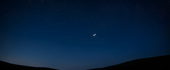 A deep navy blue night sky sprinkled with tiny, glowing stars, with a faint crescent moon glowing softly in one corner.