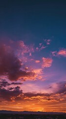 Fototapeta premium Golden sunset over a serene landscape, warm light through clouds, orange and purple hues blending in harmony