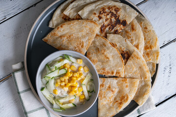 roti with corn and cucumber yogurt dip