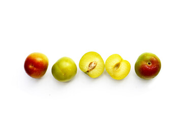 Fresh green plum fruit on white background.