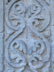 Intricate floral patterns carved into stone, showcasing the artistry of ancient Italian craftsmanship in Serramonacesca, Abruzzo