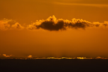 Golden sunset painting the sky over albufeira lagoon in sesimbra, portugal