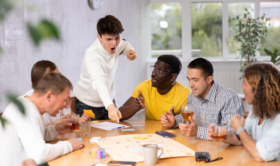 Group of men play board games during a friendly meeting indoors