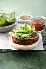 Homemade beef burger with cucumber salad