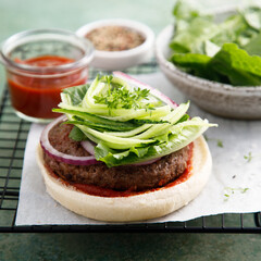 Homemade beef burger with cucumber salad