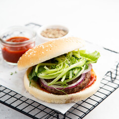 Homemade beef burger with cucumber salad
