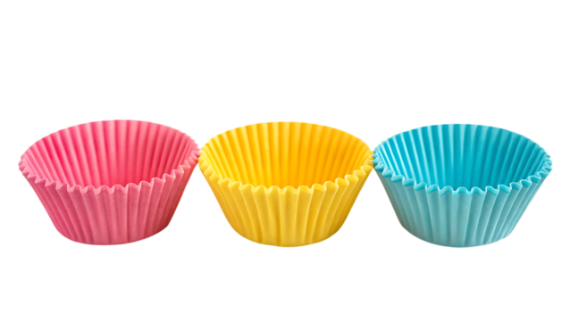 Colorful cupcake liners: pink, yellow, and blue baking cups on transparent background