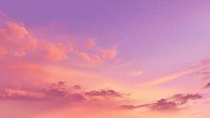 Obraz premium A serene sky with soft pink, purple, and orange clouds during sunset or sunrise.