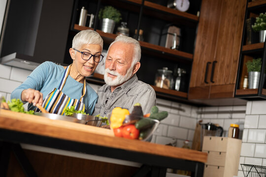 Senior couple preparing a healthy salad together at home