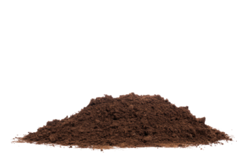 A pile of dark brown soil or dirt is seen against a plain black background in a studio setting here