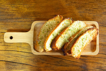 Garlic bread on wooden plate, Cooking concept.