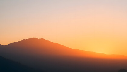 Minimalist mountain silhouette, soft fog, warm sunrise