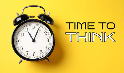 Alarm clock and words Time To Think on yellow background. Banner design