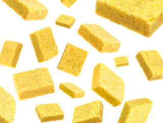 Bouillon cubes in air on white background