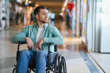 Smiling man in wheelchair shopping at the mall, overcoming mobility challenges