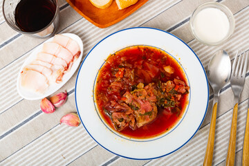 Traditional dish of Slavic cuisine called Borsch, cooked in meat broth from beets, cabbage, potatoes, carrots and onions