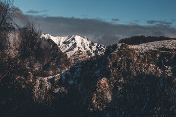 panorama with grey clouds over the snowy mountains