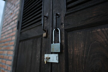 A wooden door with a lock and a key
