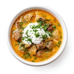 Romanian tripe soup (ciorba de burta) with sour cream, served in a white bowl, traditional hearty soup, isolated on white