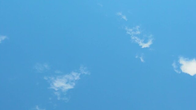 Clear Blue Azure Sky and Few White Cumulus Clouds Time Lapse, Slow Motion. Some White Puffy Clouds and Pure Blue Skyscraper, Atmosphere, Aerial Drone View, Air Plane Window View.