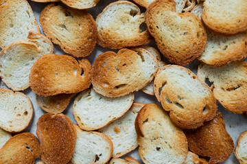 Golden brown slices of freshly toasted bread overlapping on a surface