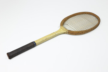 Tennis racket, old style, black handle, wooden, worn strings, on white