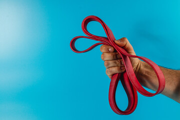 Brightly colored resistance bands held by a person's hand