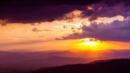 Obraz premium Golden sunset over a serene landscape, warm light through clouds, orange and purple hues blending in harmony