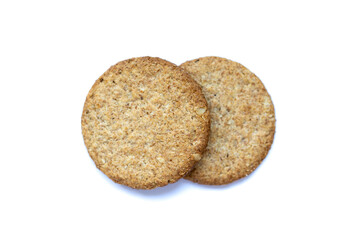 Two round oat cookies with visible grains on white background. Wholesome snack perfect for healthy diet, natural lifestyle, and soft focus food photography.