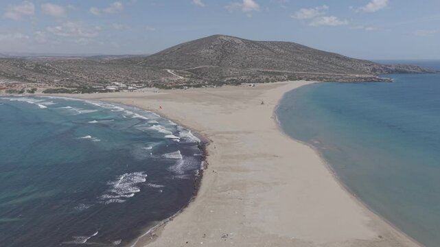 The popular Prasonisi beach in Rhodes, Greece, filmed by drone on a sunny day with perfect wind conditions for surfers.