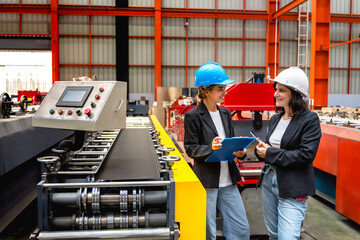 Expertise female industrial engineers working together in manufacturing industrial factory