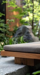 Elevated wooden platform seating with gray cushion in a tranquil garden setting