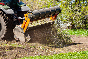 Picture of a tractor specialized in forest clearing that is in the process of destroying all the...