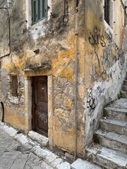 Scenic views of the historic old town of Corfu, Greece, bathed in the warm golden hour light. Charming stone buildings, narrow streets, and vibrant Mediterranean colors create a picturesque and timele
