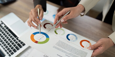 Collaborative Data Analysis. Professionals discussing financial insights with reports.