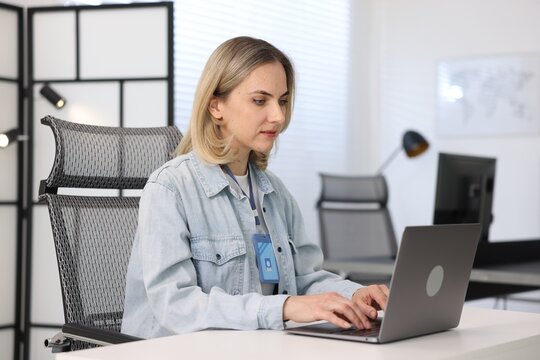 Engineer working with laptop at table in office - Powered by Adobe
