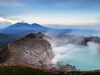 Aerial drone photo of the view of the peak of Mount Ijen Crater, with sulfur smoke and the most acidic lake in the world located in East Java, Indonesia