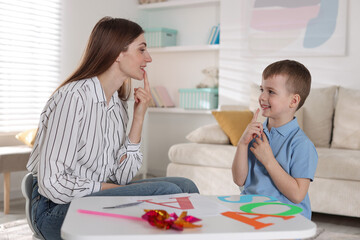 Fototapeta premium Speech therapist working with little boy indoors