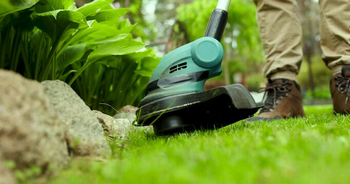 cutting grass with string trimmer. edging lawn