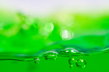 Water wave, close up of vibrant green liquid with bubbles, capturing dynamic movement and...
