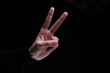 Woman's hand showing two fingers up, . Peace, fight, victory symbol, letter V in sign language or number two or second
