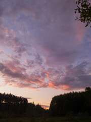 sunset in the mountains under the forest and field	