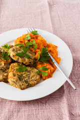 Enjoy a delicious vegetable breakfast with zucchini pancakes topped with fresh zucchini, tomato, and bell pepper caviar, offering a nutritious and flavorful start to your day