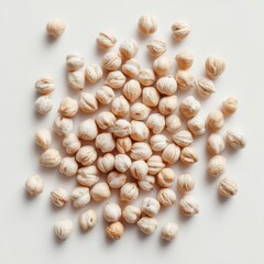 Overhead shot of dried chickpeas scattered on white background in studio lighting for food photography and healthy eating concepts