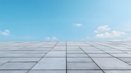 Concrete tiles stretch towards a clear blue sky, creating a business success environment.