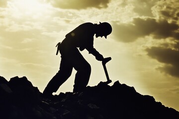 Worker toiling on a rocky hilltop