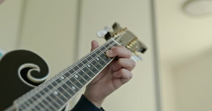 Caucasian Kid Play Mandolin at Home. European Boy Practice Music 4K 10-bit