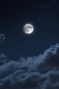 Full moon shining brightly in the night sky with clouds and stars above in a serene view