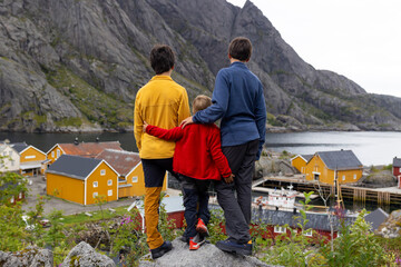Typical Rourbuer fishing cabins in Lofoten Nusfjord village on a rainy day, summertime. Traditional norwegian red house
